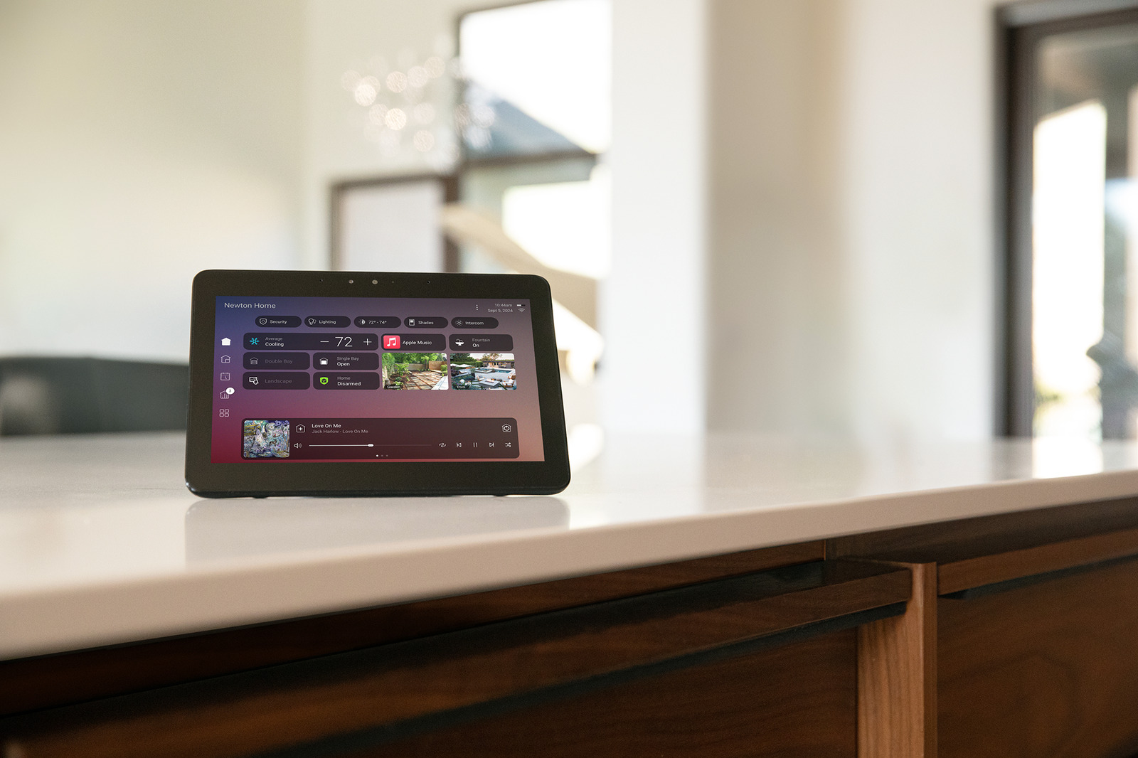 A Control4 touchscreen resting on a kitchen counter